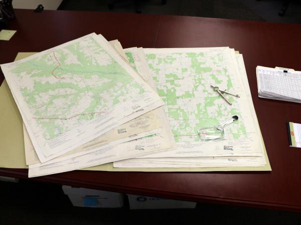 folder with maps on desk