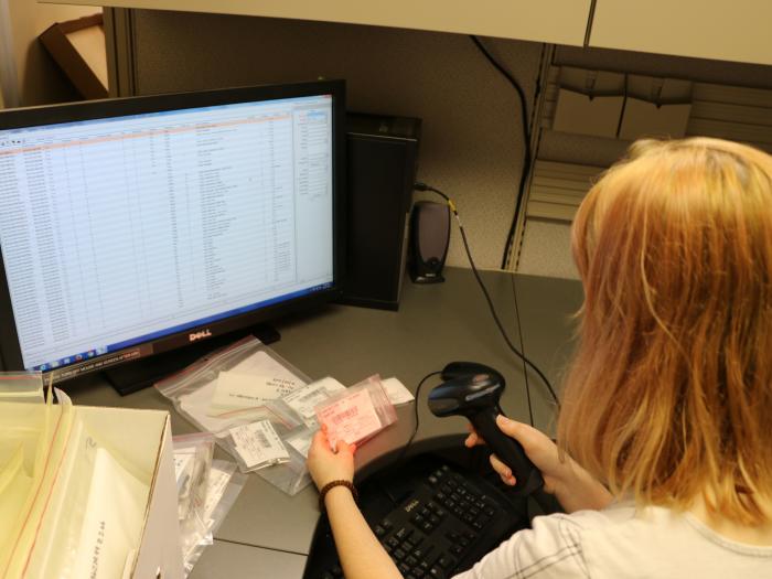 female undergraduate student using a barcode scanner to enter into database