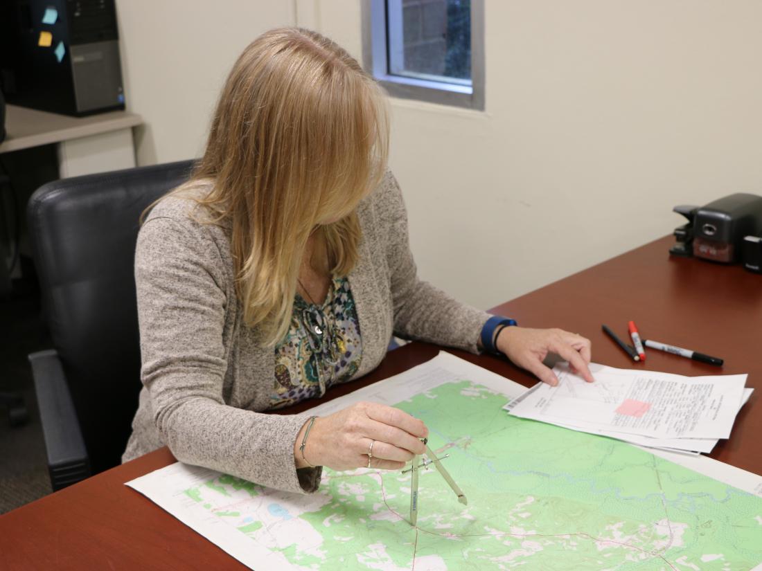 woman with a quad map doing a site search