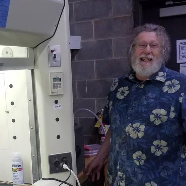 man standing to the side of a fume hood