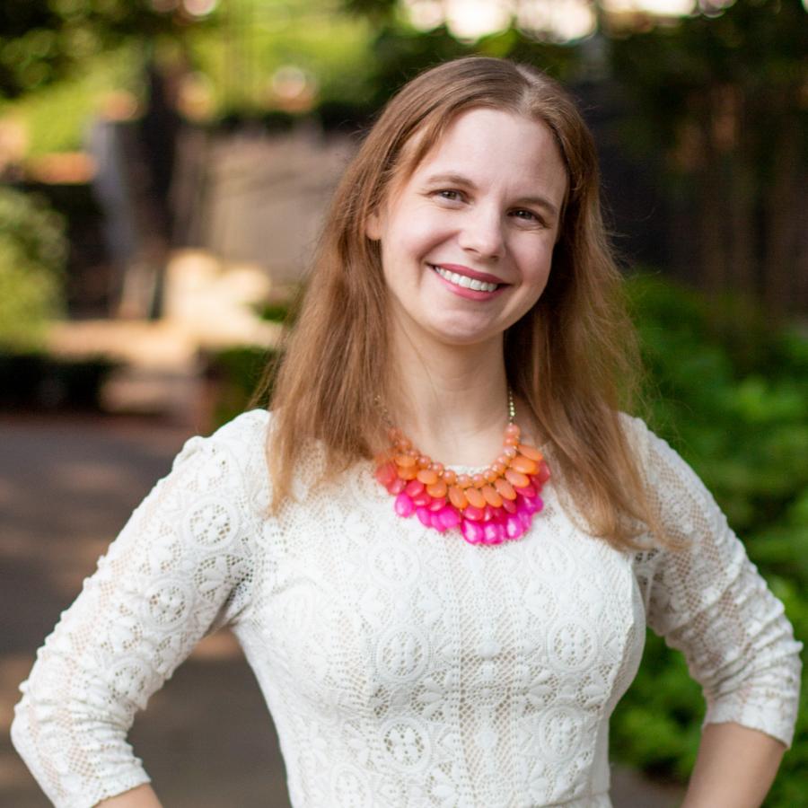 Portrait photo of Kristine outside smiling at the camera