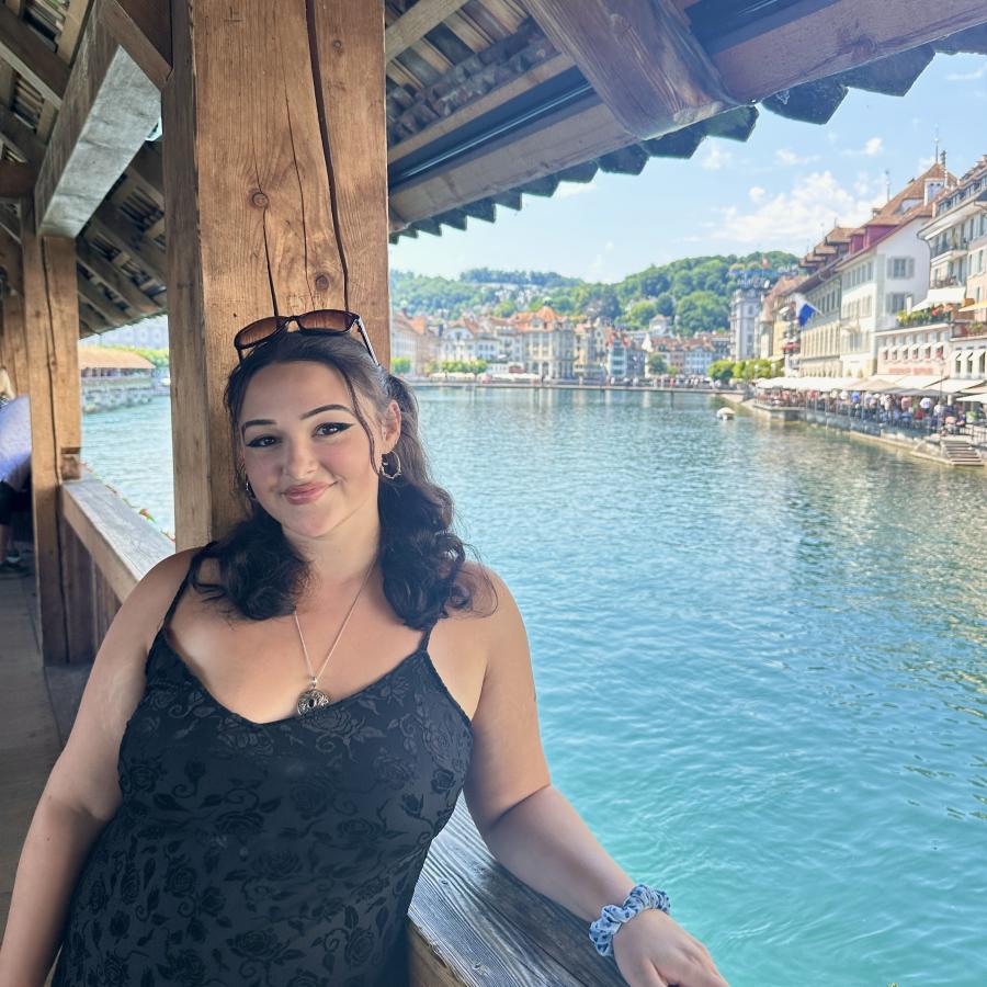 Maddy along blue water